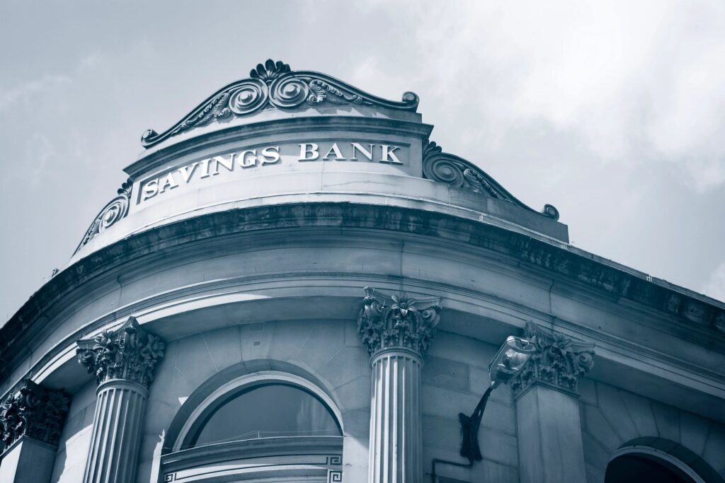 Architectural detail of a Savings Bank building featuring columns and ornate design elements.